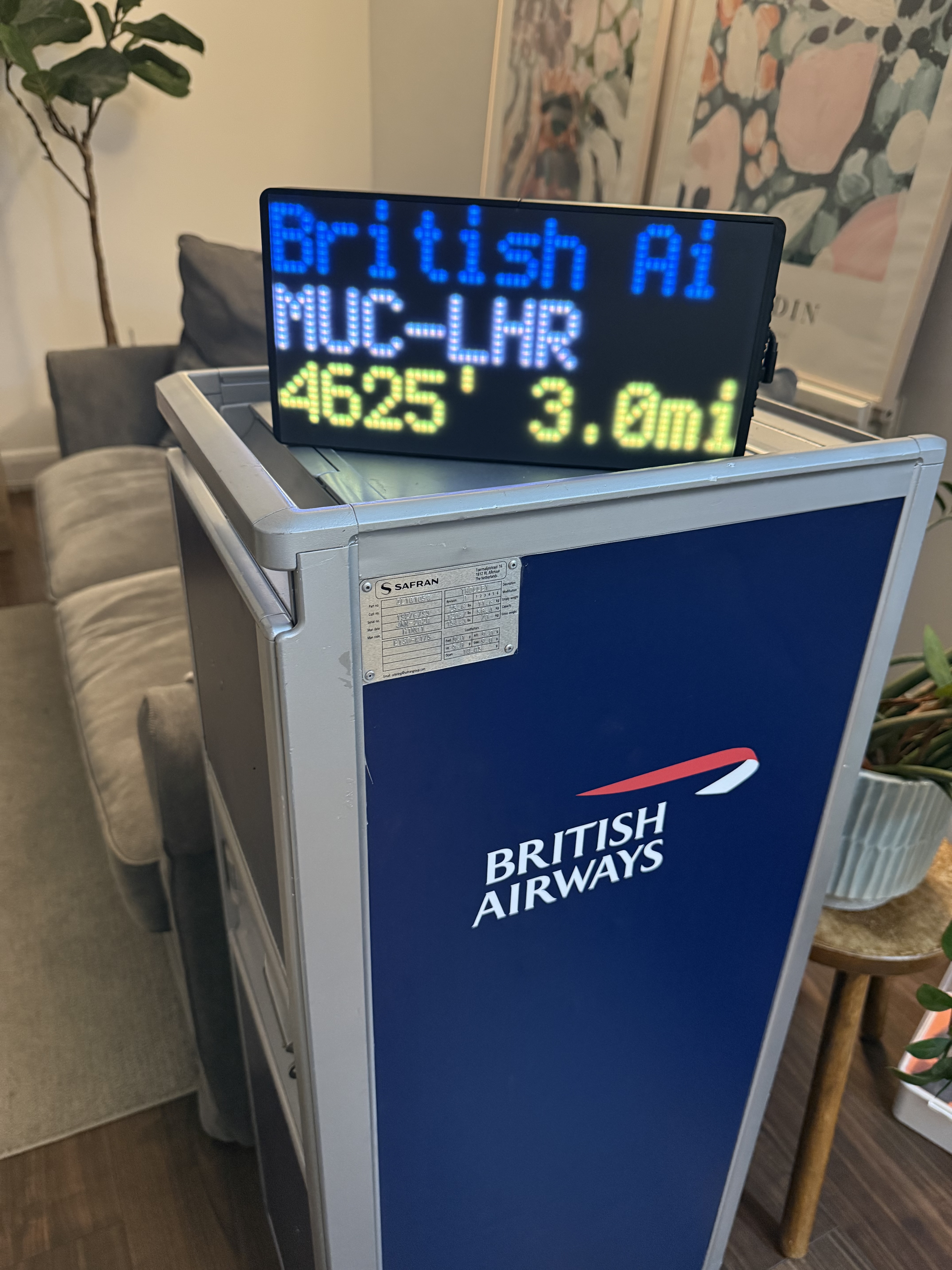 NearestPlane LED flight tracker board size comparison next to a book